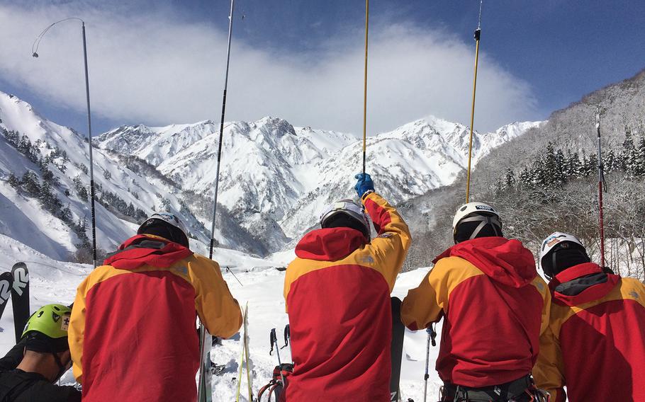 A Japanese search-and-rescue team probes avalanche debris while looking for missing U.S. skier Mathew Healy on Wednesday, Feb. 22, 2017, near Happo-one ski resort in Nagano prefecture, Japan. 