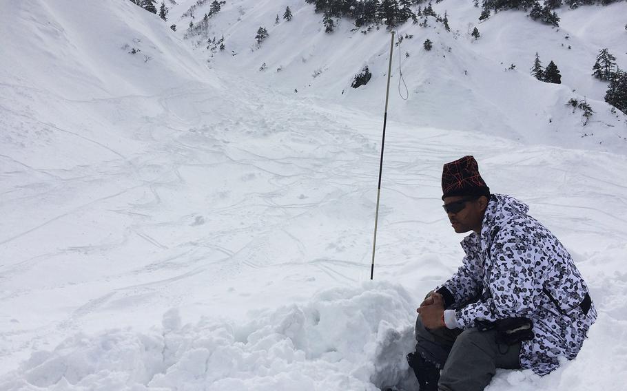 U.S. Air Force Master Sgt. Stacy Morrow, 42, takes a break from searching for a missing U.S. skier near Happo-one Ski resort Wednesday.

Seth Robson/Stars and Stripes