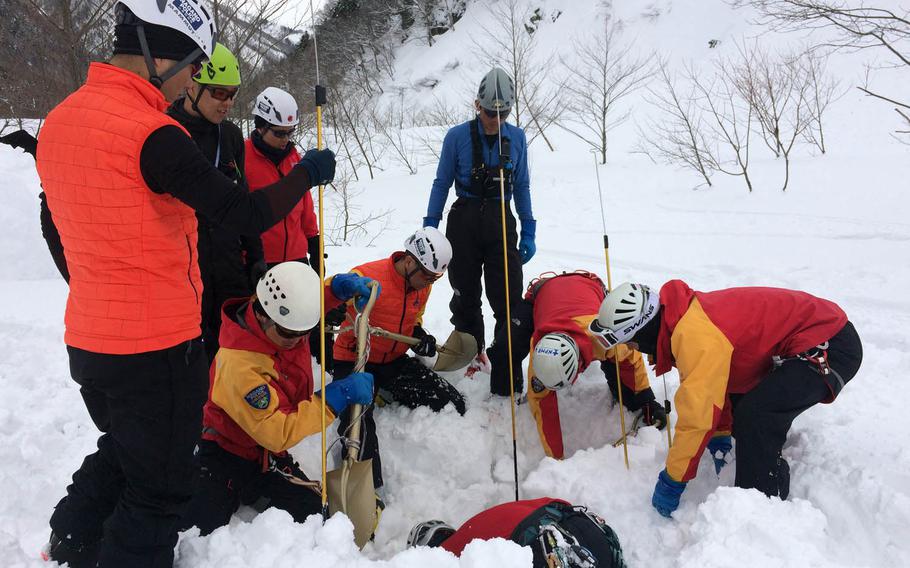 Japanese police search for missing skier Mathew Healy, a Navy civilian who worked in Okinawa, Japan, near Happo-one ski resort in Nagano, Japan, Wednesday, Feb. 22, 2017. 