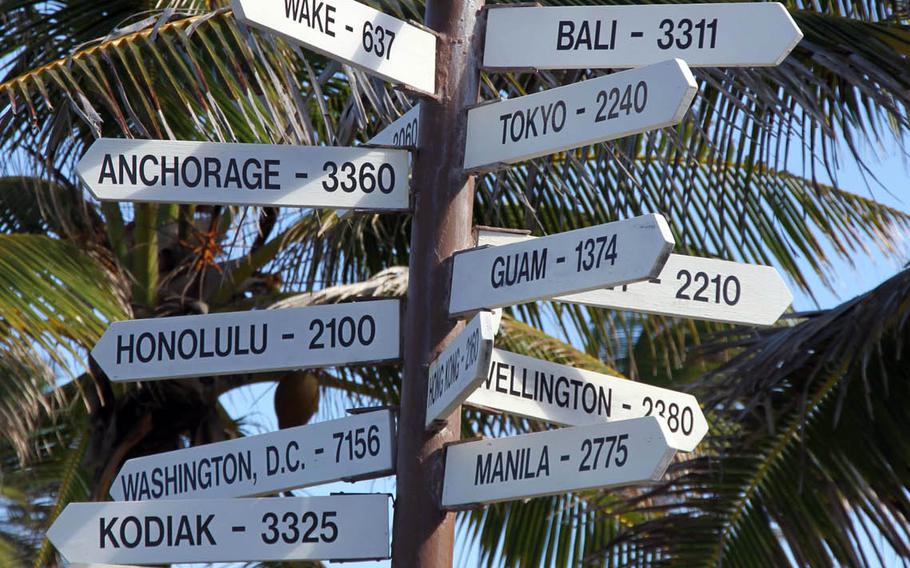 A signpost on Kwajalein Island, a tiny island in the Pacific Ocean, reminds residents that they are a long, long way from the rest of the world. 
