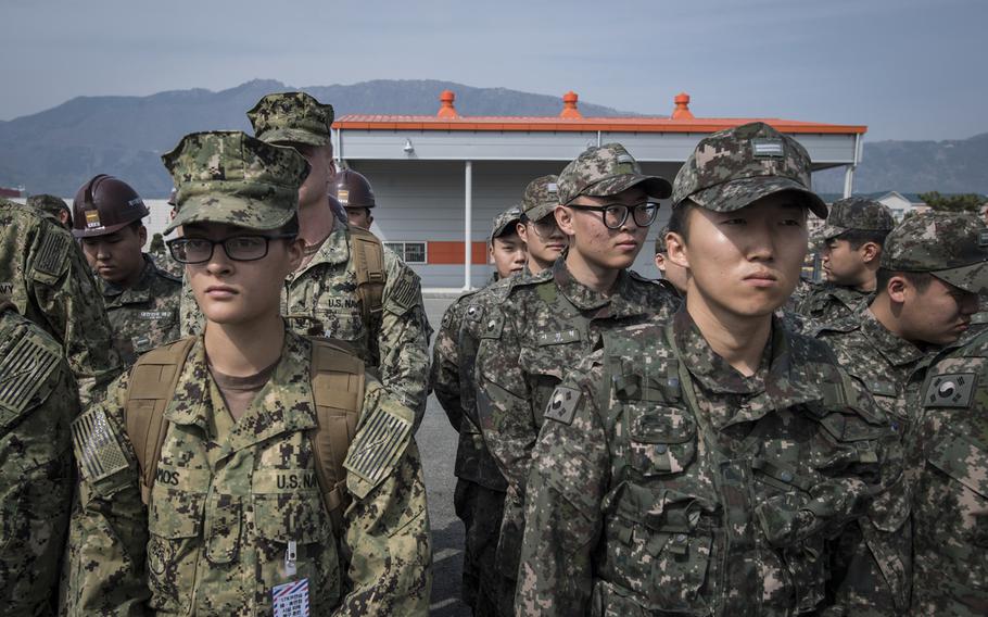 Naval Mobile Construction Battalion 5 sailors and South Korean sailors listen to a briefing as part of the Foal Eagle exercise in Jinhae, South Korea, on March 13, 2017.