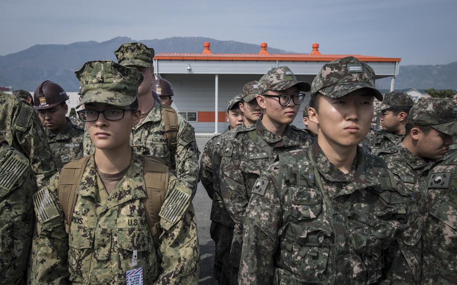 Naval Mobile Construction Battalion 5 sailors and South Korean sailors listen to a briefing as part of the Foal Eagle exercise in Jinhae, South Korea, on March 13, 2017. 