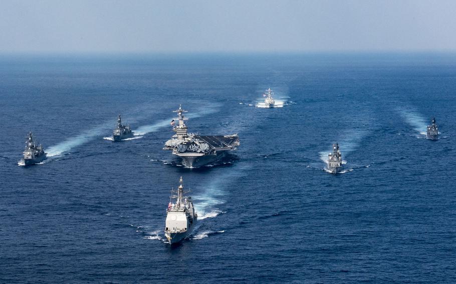 The aircraft carrier USS Carl Vinson (CVN 70), the guided-missile destroyer USS Wayne E. Meyer (DDG 108) and the guided-missile cruiser USS Lake Champlain (CG 57) participate in a photo exercise with Japan Maritime Self-Defense Force destroyers in the Philippine Sea March 28, 2017.