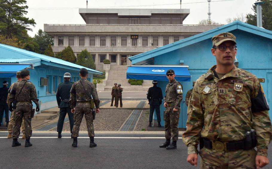 North Korean soldiers film Vice President Mike Pence from their side of the Demarcation Line that divides the peninsula at the Joint Security Area, Monday, April 17, 2017.