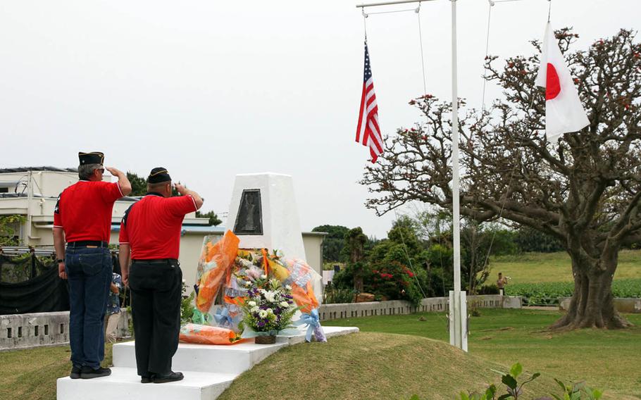 Members of Okinawa's American Legion Post 28 salute Ernie Pyle at the memorial marking the site of the acclaimed World War II correspondent's death, during a ceremony on Sunday, April 16, 2017, in Ie Shima, Okinawa. 