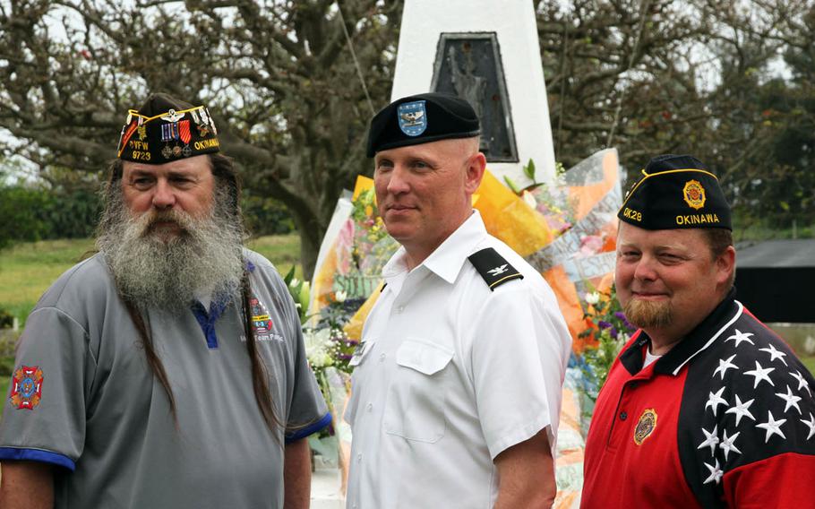 Army Col. Derek Jansen, 10th Regional Support Group commander, center, poses with members of Okinawa's American Legion Post 28 and Veterans of Foreign Wars Post 9723 at the memorial for acclaimed World War II correspondent Ernie Pyle on Ie Shima, Japan, on Sunday, April 16, 2017.