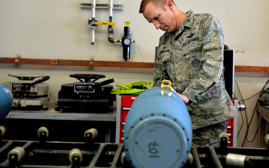 Col. Case Cunningham performs maintenance on an inert GBU-12 Paveway II laser-guided bomb in 2016 at Creech Air Force Base, Nevada. Cunningham has been selected to lead the 18th Wing at Kadena Air Base, Japan, and for promotion to brigadier general.