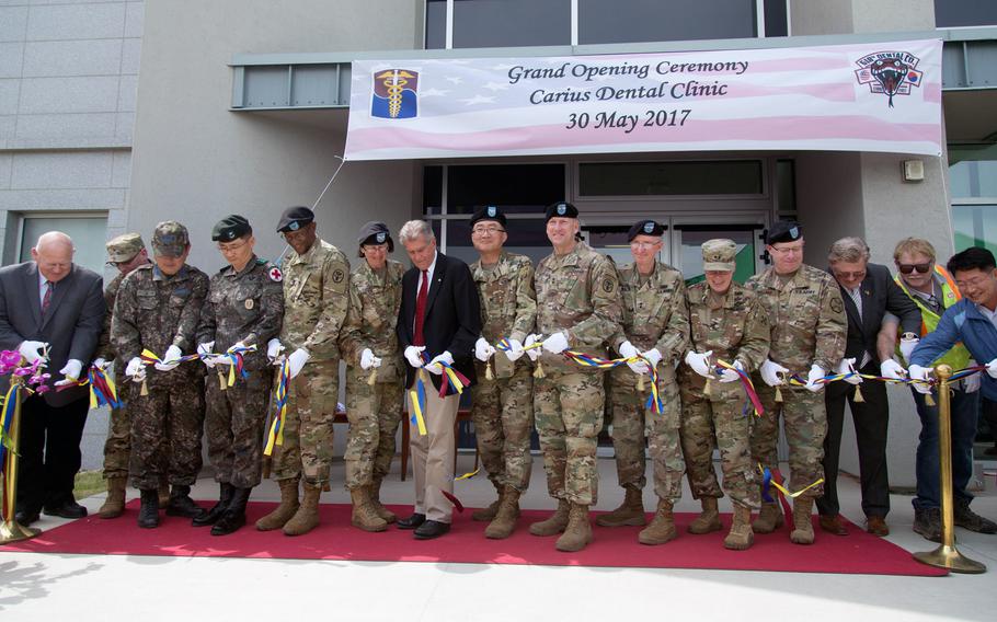 Dignitaries cut the ribbon at the Carius Dental Clinic grand opening on Camp Humphreys, South Korea, May 30, 2017. 