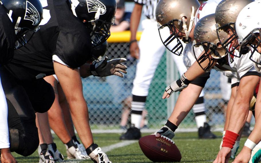 Players line up for a play during a U.S. Forces Japan-American Football league game in Yokosuka, Japan, in June 2009.