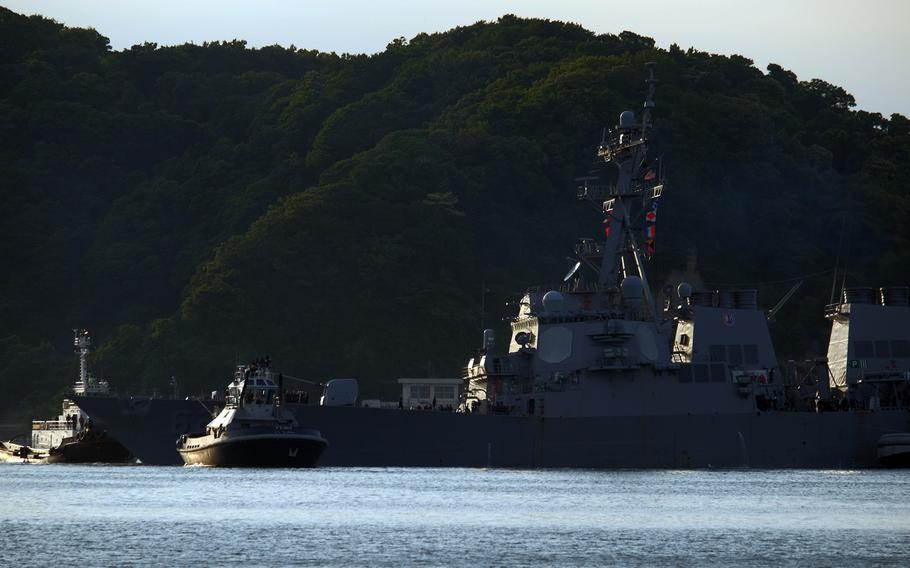 The USS Fitzgerald being pulled into Yokosuka Naval Base, Japan, with assistance from tug boats on Saturday, June 17, 2017.