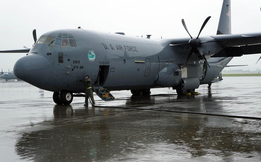 A crew chief unplugs a ground power unit before the first operational flight of one of the 374th Airlift Wing's new C-130J Super Hercules cargo aircraft at Yokota Air Base, Japan, Friday, June 30, 2017.