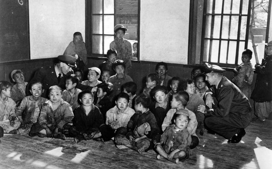 New arrivals at the 5th Air Force's Seoul processing center for orphans, before evacuation to Jeju Island on Dec. 20, 1950. With them are Chaplain Col. Wallace Wolverton, left, and Chaplain Lt. Col. Russell Blaisdell.