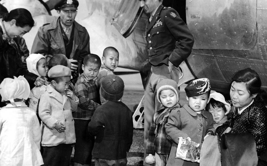 Chaplain Lt. Col. Russell Blaisdell, left, and Lt. Col. Dean Hess, right, visit Jeju Island after saving nearly 1,000 Korean orphans in late 1950. The children were well fed and clothed. 