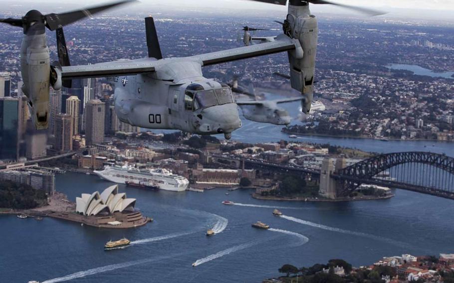 A set of MV-22B Osprey tilt-rotor aircraft from Marine Medium Tiltrotor Squadron 265 fly in formation above Sydney Harbor, Australia, Thursday, June 29, 2017.