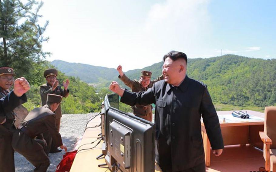 Photos published by the state-run Korean Central News Agency purportedly show North Korean leader Kim Jong Un, officers and soldiers celebrating after what the communist state claims was its first successful test of an intercontinental ballistic missile on Tuesday, July 4, 2017.