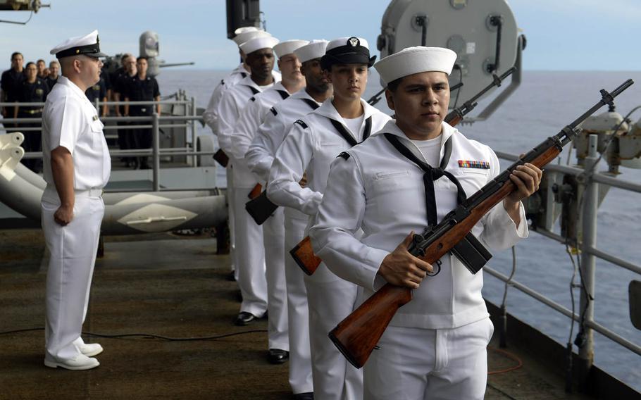 Sailors perform a 21-gun salute during a ceremony for the Battle of Leyte Gulf aboard the aircraft carrier USS Nimitz near the Philippines, Monday, July 3, 2017.