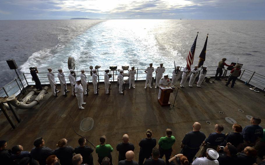 Sailors aboard the aircraft carrier USS Nimitz remember the Battle of Leyte Gulf near the Philippines, Monday, July 3, 2017. 