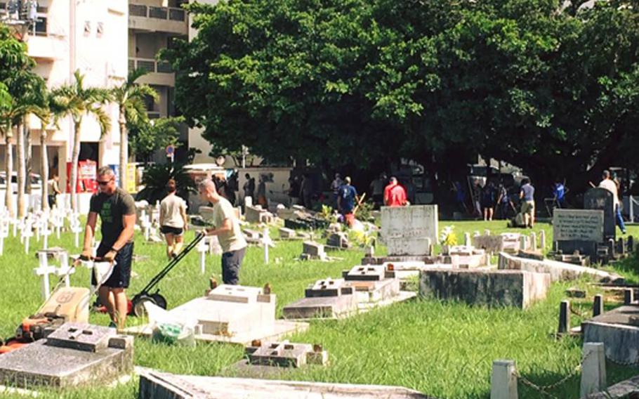 Members of Okinawa's American Legion Post 28 clean Tomari International Cemetery in Naha last month. 