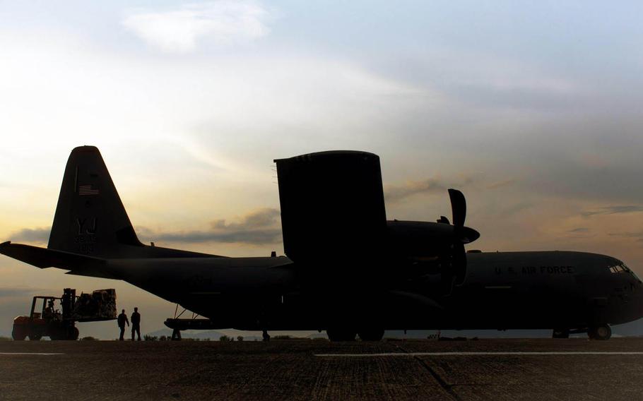 Airmen load cargo onto a Super Hercules during Yokota Air Base's first operational C-130J mission at Clark Air Base, Philippines.