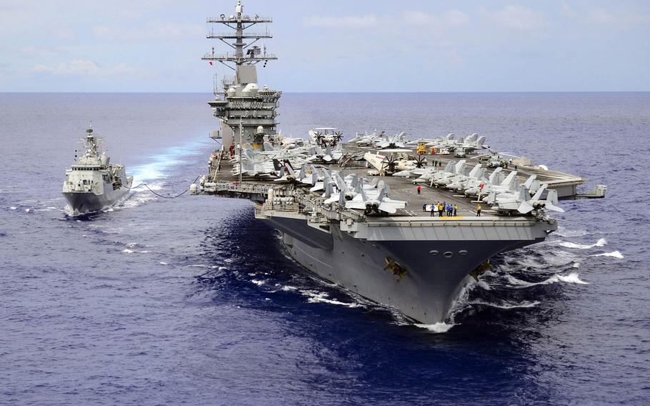 The aircraft carrier USS Nimitz conducts a replenishment at sea with the Royal New Zealand Navy frigate HMNZS Te Kaha in the Philippine Sea, July 2, 2017. 