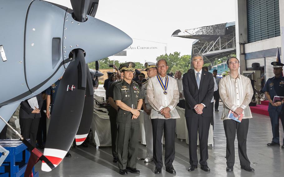 U.S. and Philippine officials gather at Villamor Air Base in Pasay City, Philippines, for a ceremony to transfer two new Cessna 208B surveillance planes to the Philippine Air Force, July 27, 2017.