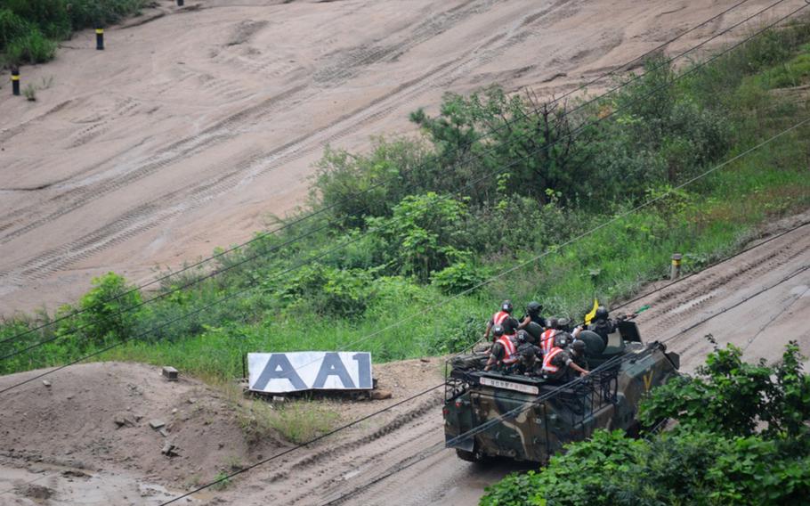 Soldiers move to a firing point during a combined live-fire exercise Aug. 5, 2015, at Chipori Range near Cheorwon, South Korea.
