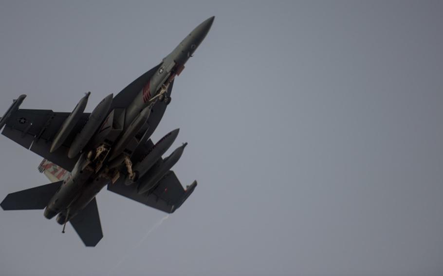 An EA-18G Growler from the Electronic Attack Squadron flies over the flight deck of the Navy's forward-deployed aircraft carrier USS Ronald Reagan during Talisman Saber 2017. 