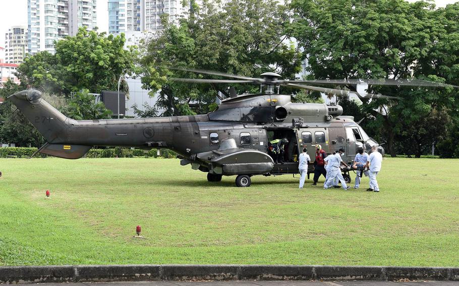 This photo posted to the Singapore Navy's official Facebook page shows a sailor injured in the USS John S. McCain collision being taken to a hospital in Singapore. The U.S. Navy said the four of five injured sailors did not have life-threatening injuries.
