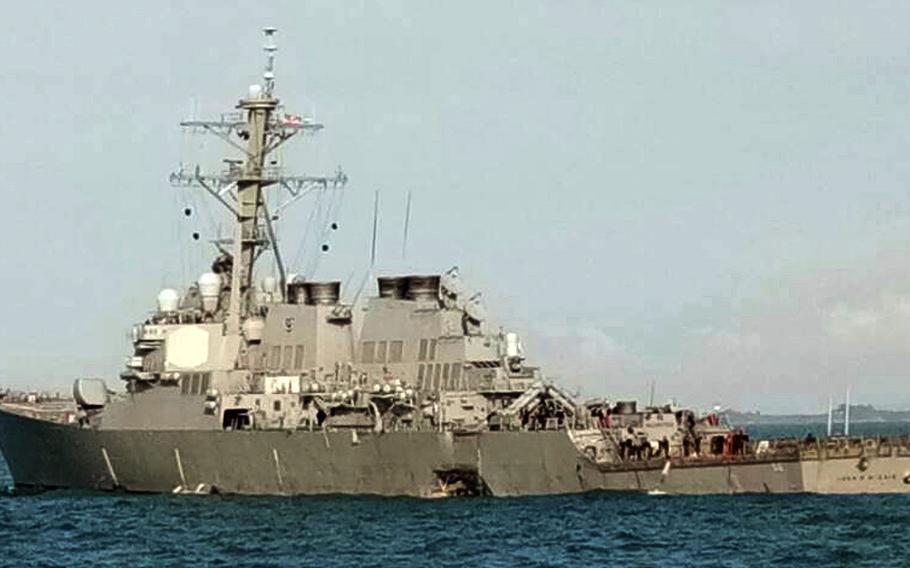 In this photo released by the Royal Malaysian Navy,  the damaged U.S guided-missile destroyer USS John S. McCain is seen off Johor, Malaysia, Monday, Aug. 21, 2017.