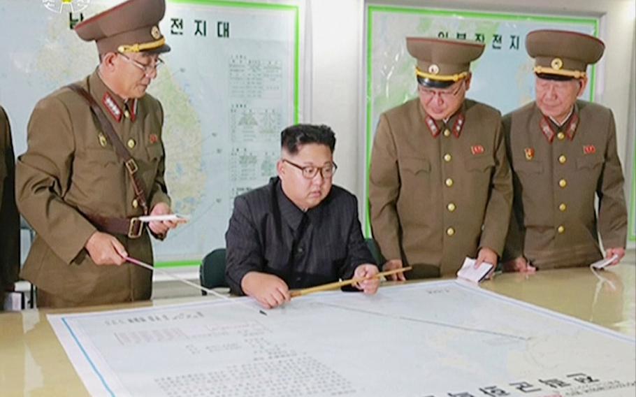 A screen grab from an Aug. 14, 2017 video broadcast shows North Korean leader Kim Jong Un receiving a military briefing in Pyongyang.