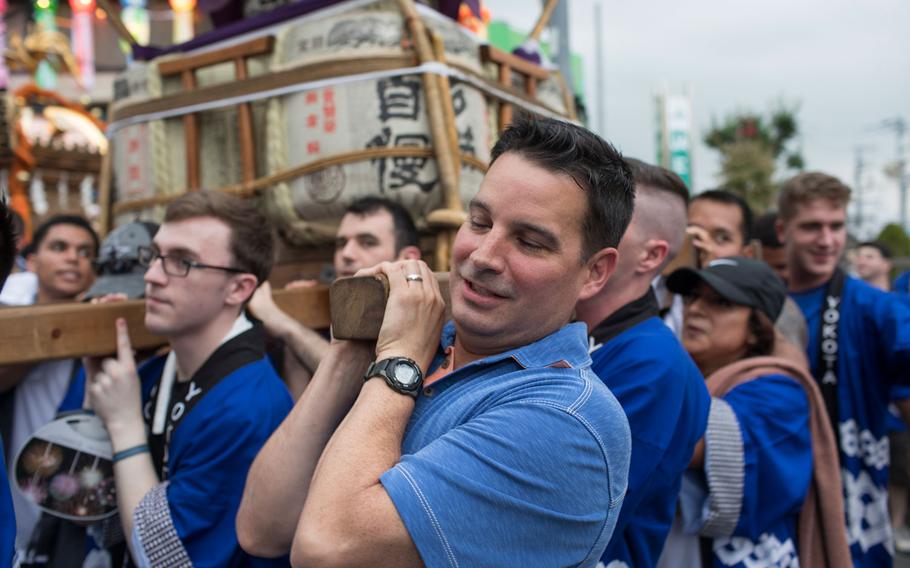 Col. Sergio Vega Jr., 374th Airlift Wing vice commander, carries the wing mikoshi during the 67th Annual Fussa Tanabata Festival at Fussa City, Japan, Aug. 4, 2017. The festival gave Yokota members an opportunity to build friendships with the local community while experiencing Japanese culture.