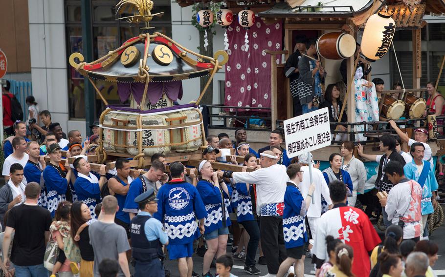 Members from Yokota Air Base carry the wing mikoshi, or a portable shrine, during the 67th Annual Fussa Tanabata Featival at Fussa City, Japan, Aug. 4, 2017.