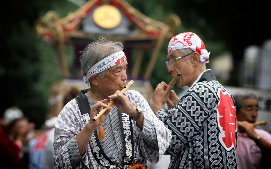 Members from the Fussa Tennou Hayashi Hozonkai play Japanese flutes during the 67th Annual Fussa Tanabata Festival at Fussa City, Japan, Aug. 4, 2017. A form of Japanese music, called "hayashi" roused the movement of parade floats.