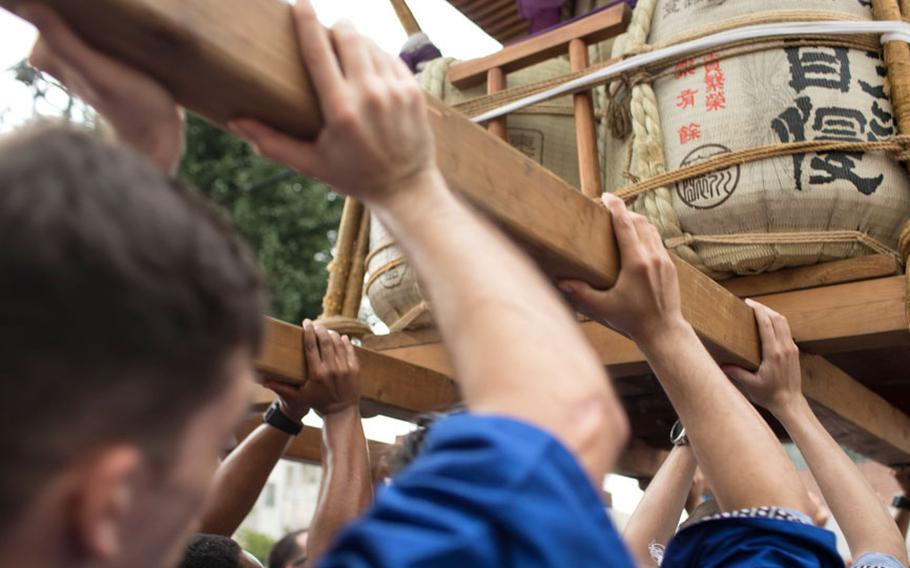 Members from Yokota Air Base carry the wing mikoshi, or a portable shrine, during the 67th Annual Fussa Tanabata Festival at Fussa City, Japan, Aug. 4, 2017. More than 80 volunteers from Yokota carried the shrine during this year's festival; Yokota Airmen have attended the festival since 1958 and have actively participated in carrying a mikoshi since 1975.