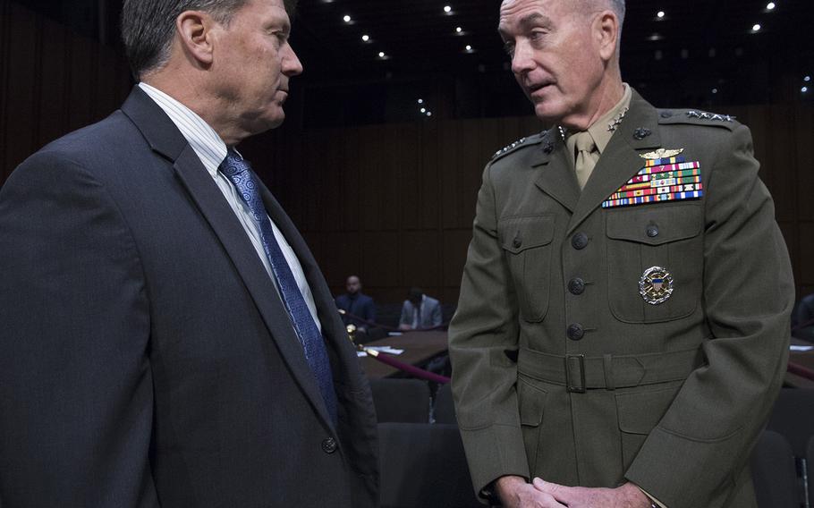 Gen. Joseph Dunford, chairman of the Joint Chiefs of Staff, talks with Sen. Mike Rounds, R-S.D., before Dunford's reappointment hearing on Capitol Hill, Sept. 26, 2017.