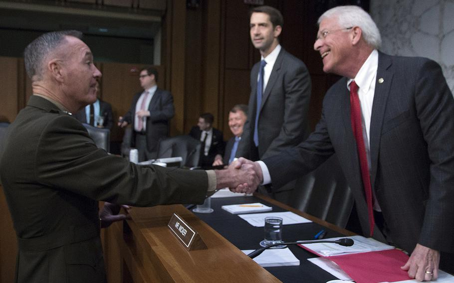 Gen. Joseph Dunford, chairman of the Joint Chiefs of Staff, shakes hands with Sen. Roger Wicker, R-Miss., before Dunford's Senate Armed Services Committee reappointment hearing on Capitol Hill, Sept. 26, 2017.
