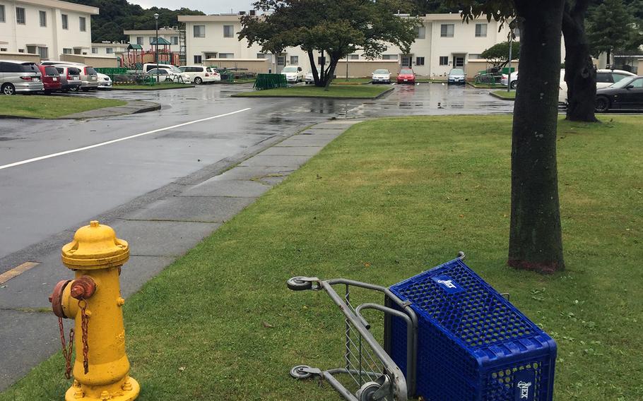 An overturned shopping cart near a housing area at Yokosuka Naval Base.