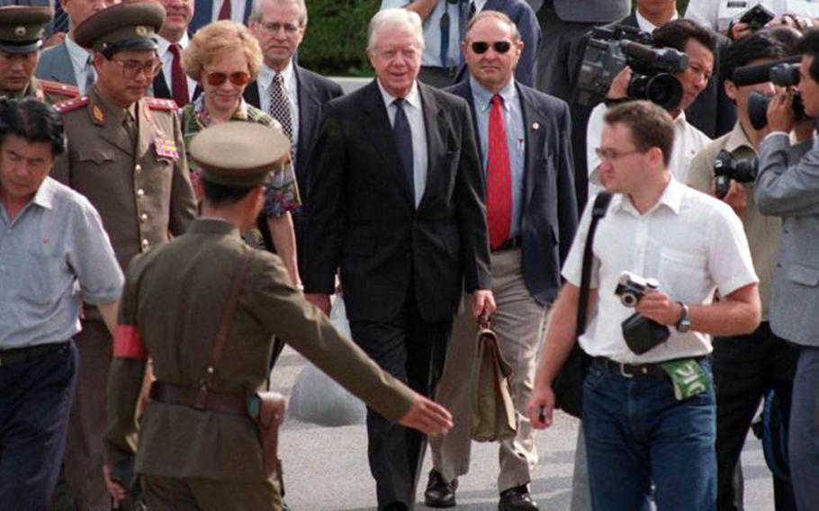 Former President Jimmy Carter crosses through the Joint Security Area of the Demilitarized Zone en route to visit then-North Korean leader Kim Il Sung to defuse a crisis in June 1994.

