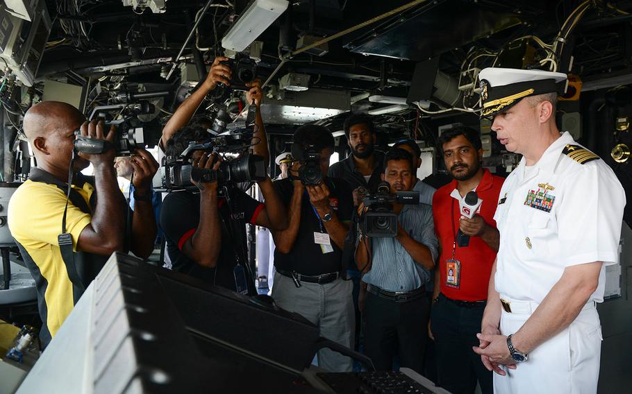 U.S. Navy Capt. Justin A. Kubu, commanding officer of the USS Princeton, gives a tour of the bridge to Sri Lankan media during a regularly scheduled port visit in Colombo, Sri Lanka on Oct. 28, 2017.