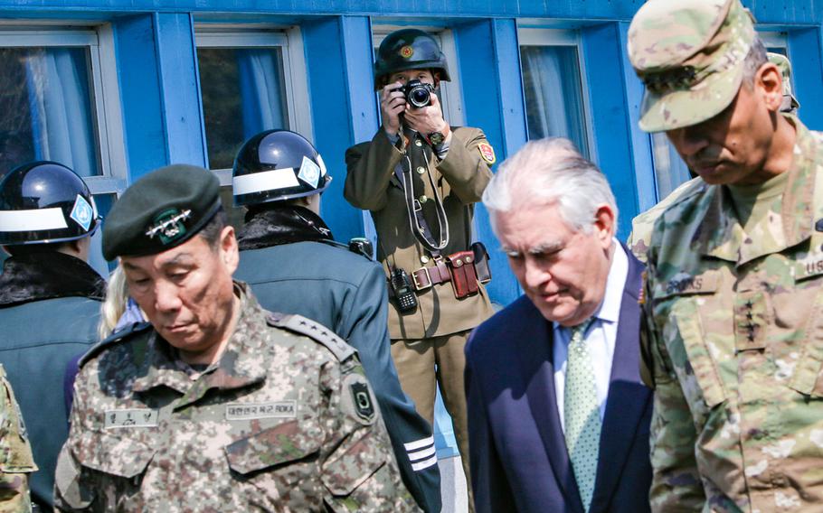 A North Korean People's Army service member photographs Republic of Korea Gen. Leem Ho-young, Combined Forces Command Deputy Commander; Gen. Vincent K. Brooks, United Nations Commander, Combined Forces Commander, and United States Forces Korea commander; and U.S. Secretary of State Rex Tillerson at the Korean border located inside the Joint Security Area on Mar. 17, 2017.