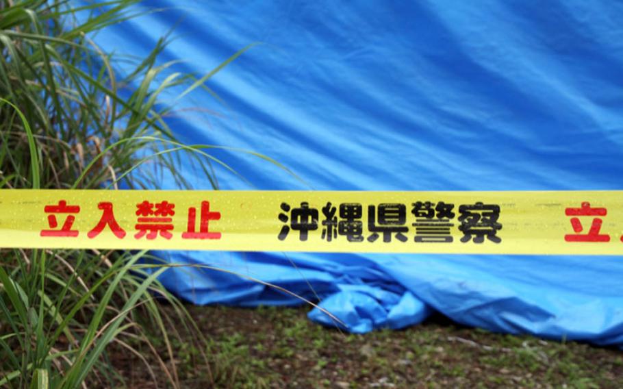 Police tape and a blue tarp mark the site where the body of Rina Shimabukuro was found on Okinawa in 2016.