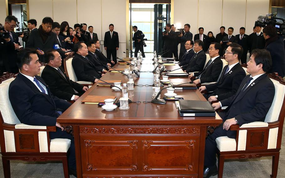 Members of the North Korean delegation, left, sit across from South Korean officials during the first high-level talks between the two countries in more than two years, Tuesday, Jan. 9, 2017. The meeting took place in the truce village of Panmunjom.