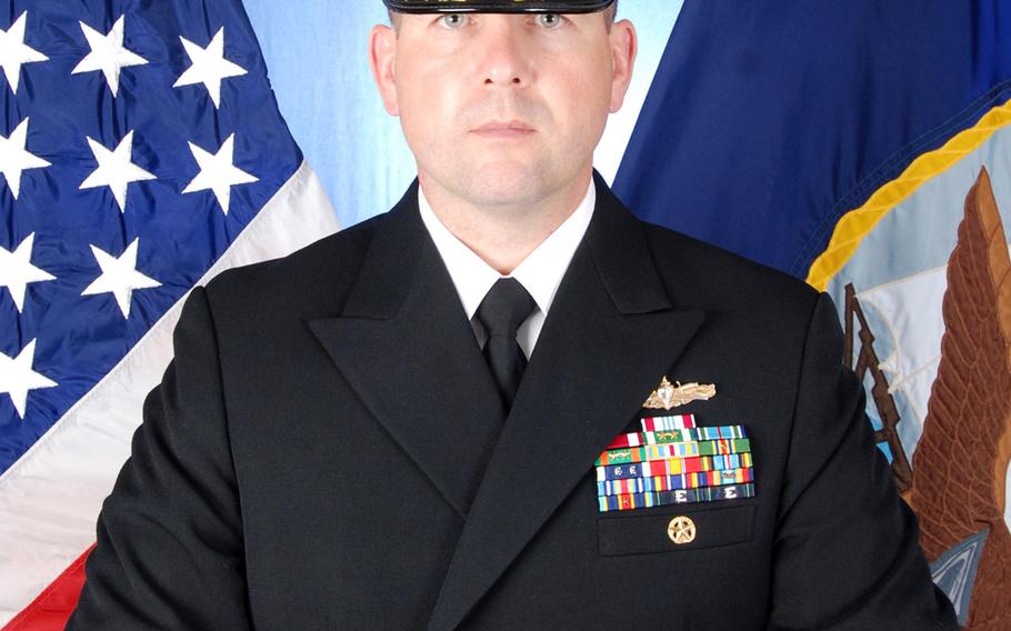 The Navy said it is filing at least three charges against four officers of the USS Fitzgerald, including the commanding officer, who was Cmdr. Bryce Benson at the time. A Navy investigation found that Benson left the ship's bridge before the collision. Also facing charges are two lieutenants and one lieutenant junior grade, whose names were not disclosed.
