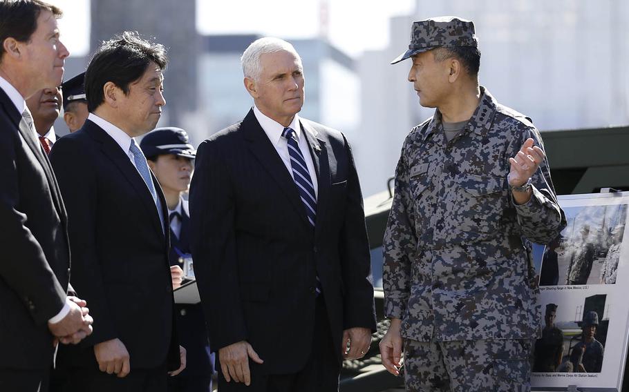 U.S. Vice President Mike Pence, second from right, speaks with an officer of the Japan's Ground Self-Defense Force as he inspects a PAC-3 interceptor missile system with Japanese Defense Minister Itsunori Onodera, second from left, at Defense Ministry in Tokyo Wednesday, Feb. 7, 2018. 