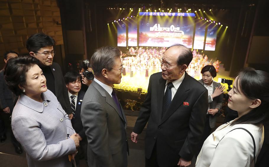 In this photo provided by South Korea Presidential Blue House, South Korean President Moon Jae-in, center, talks with North Korea's nominal head of state Kim Yong Nam and Kim Yo Jong, right, North Korean leader Kim Jong Un's sister, after a performance of North Korea's Samjiyon Orchestra at National Theater in Seoul, South Korea, Sunday, Feb. 11, 2018.