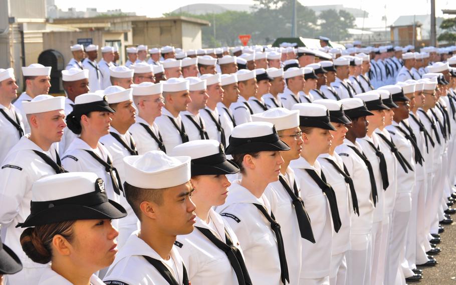 Sailors assigned to U.S. Naval Hospital Yokosuka stand at parade rest during a dress white uniform inspection.