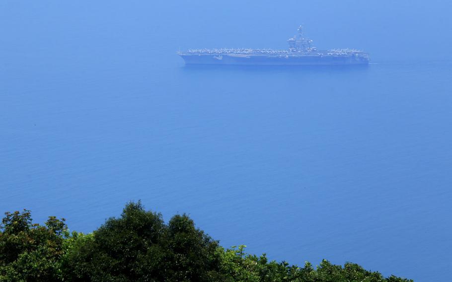 USS Carl Vinson sails in Danang Bay Monday, March 5, 2018 in Danang, Vietnam. For the first time since the Vietnam War, the U.S. Navy aircraft carrier is visiting a Vietnamese port, seeking to bolster both countries' efforts to stem expansionism by China in the South China Sea.