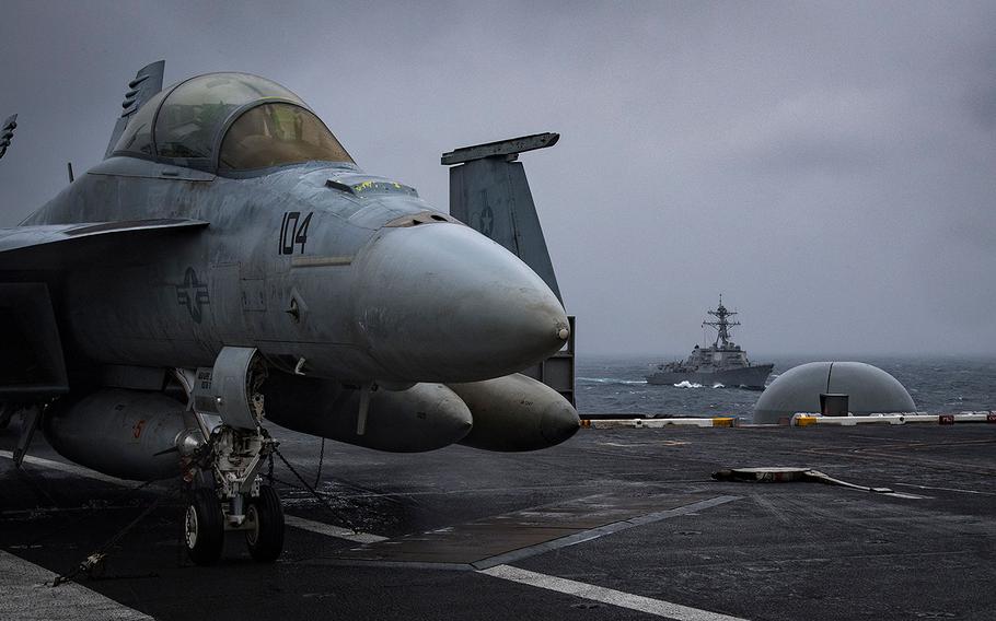 The guided-missile destroyer USS Wayne E. Meyer steams alongside the aircraft carrier USS Carl Vinson in the South China Sea, on March 9, 2018.