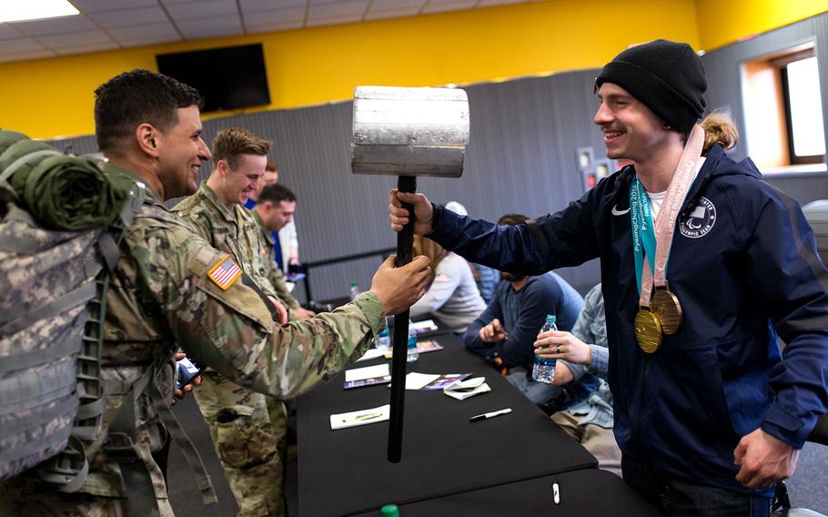 Paralympian Noah Elliott checks out a soldier's hammer at Camp Casey, South Korea, Saturday, March 17, 2018. 