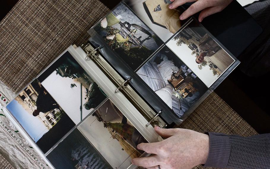 Chief Warrant Officer 3 Lindsey Muller shows old war photos from her tour to Iraq on Thursday, March 29, 2018.